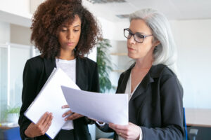 False Imprisonment Lawyers: How a Police Misconduct Attorney in Los Angeles Can Help 2 Woman reviewing documents with a professional.