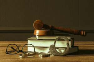 Excessive Force by Police: Understanding Your Legal Rights 2 Law books, glasses, handcuffs, and a gavel representing the legal system.