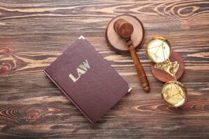 What Is Qualified Immunity? How It Impacts Civil Rights Cases in California 1 Overhead view of a law book with a gavel and scales of justice.