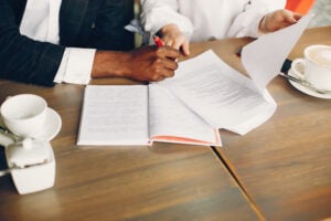 Can You Counter Sue for a Frivolous Lawsuit? 1 People reviewing legal documents at office table