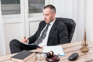 When Can Physical Force Be Used to Prevent Harm? 1 Attorney reviewing legal notes at a desk