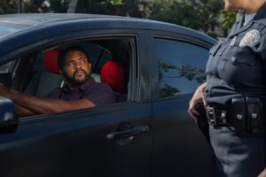 How Long Can Police Keep You at a Traffic Stop in California? 1 Police officer speaking with a driver during a roadside traffic stop.